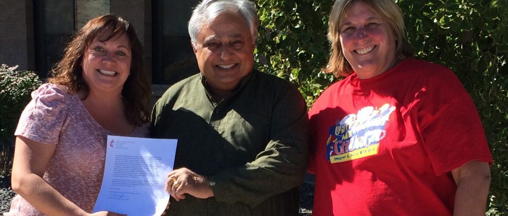 Rajan Zed receiving a testimonial at South Reno United Methodist Church. From left to right are—Dawn Pidlypchak, Rajan Zed and Pastor Becky Stockdale.